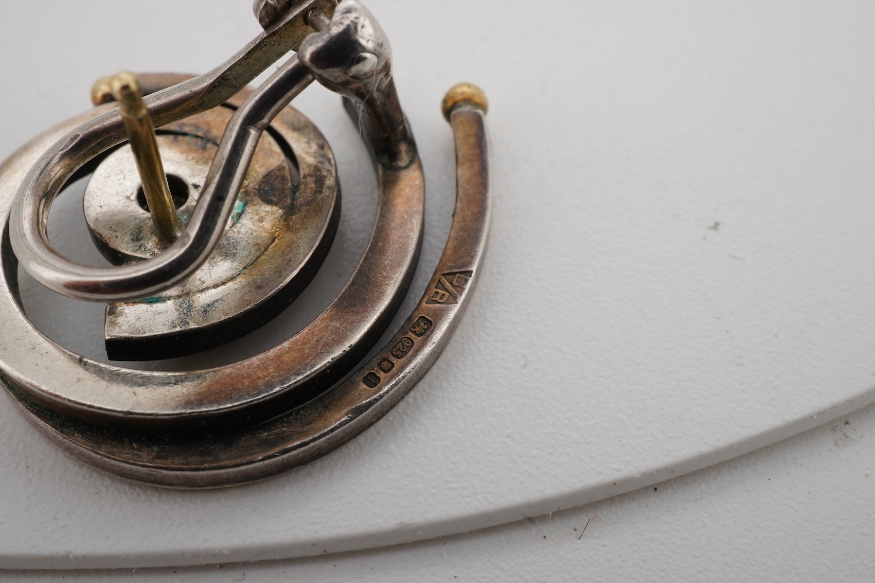 Two pairs of diamond earrings, comprising: one pair of woven design, set with brilliant-cut diamonds totalling approximately 0.10 carats, mounted in bicoloured 18ct gold, length 2.4cm each, post fittings, British hallmar